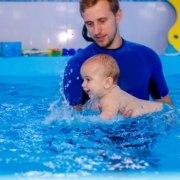 a-baby-swims-with-an-instructor-in-the-pool-the-c-2022-11-16-13-37-36-utc